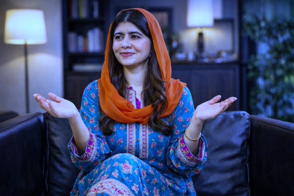 Blue suit aur orange dupatta pehne haath phela kar baat karte hue