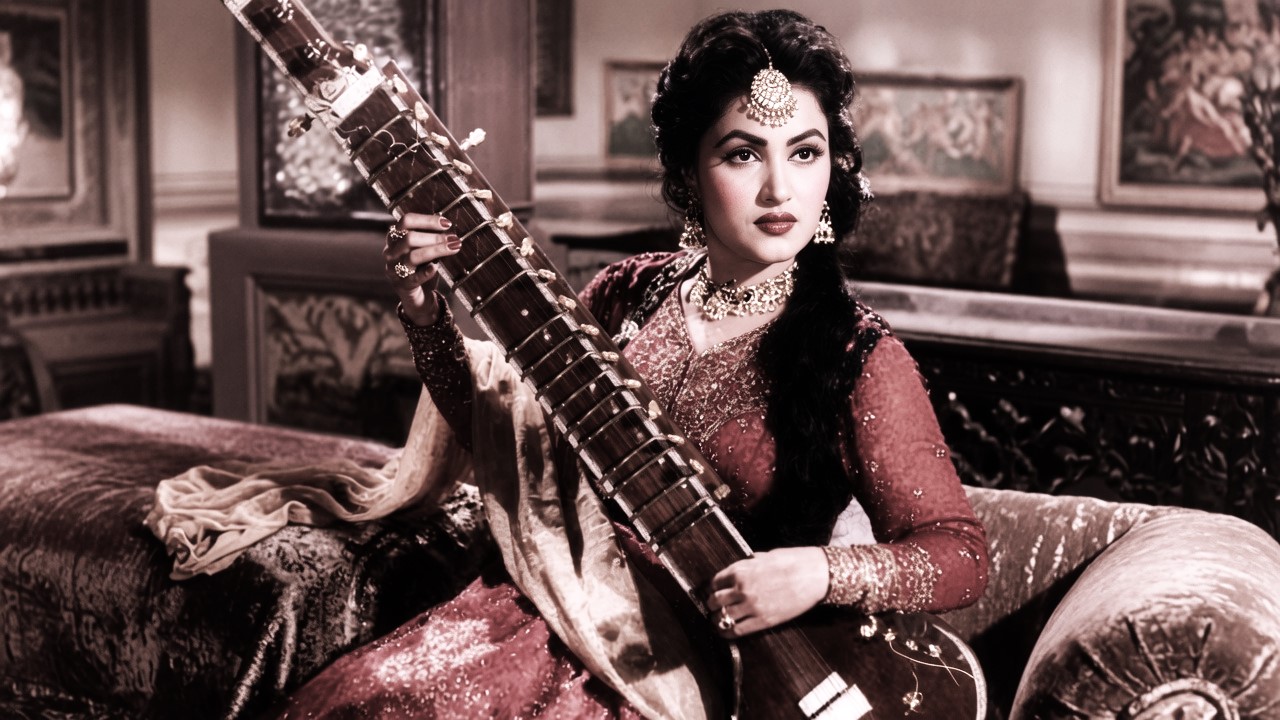 Playing sitar in traditional attire