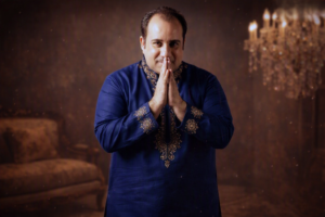 Formal portrait with folded hands and warm smile
