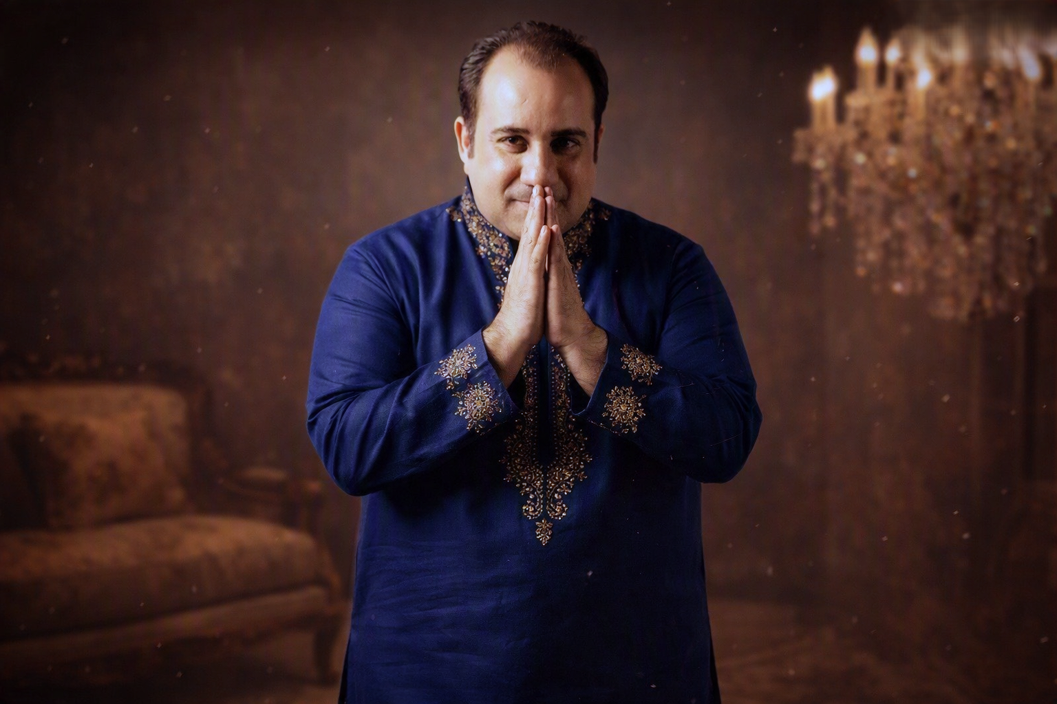 Formal portrait with folded hands and warm smile