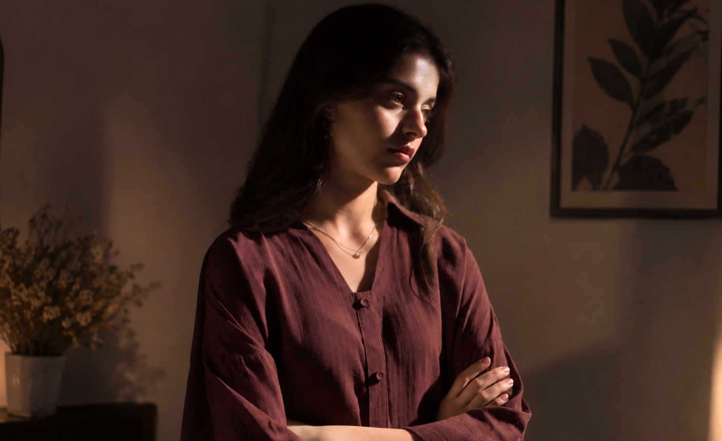 Dark maroon dress mein serious expression ke sath talented actress