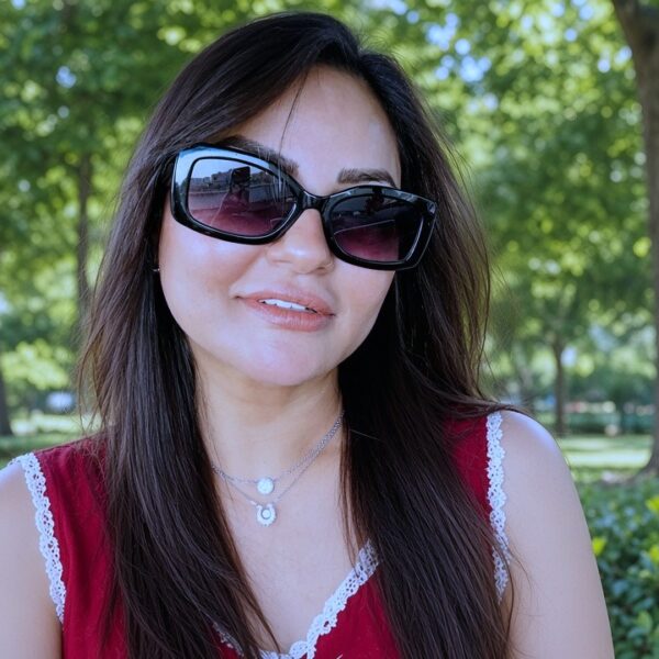 Prominent actress wearing red top and sunglasses outdoor